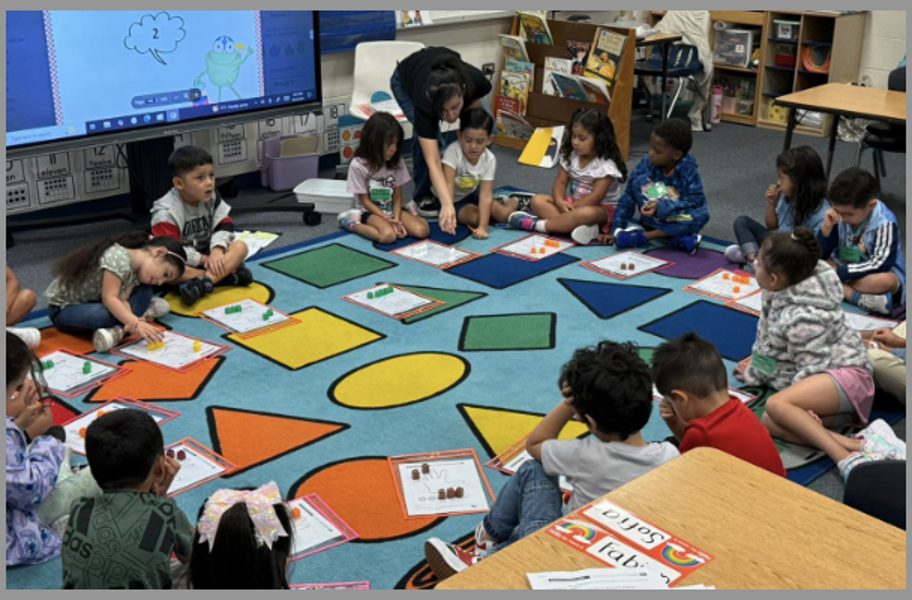Pre-K students and their teacher working on a shapes lesson